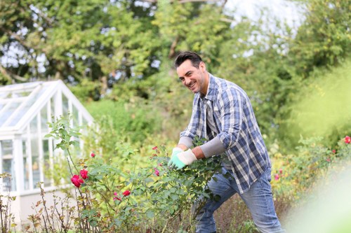Worker wearing protective gear operating garden equipment safely
